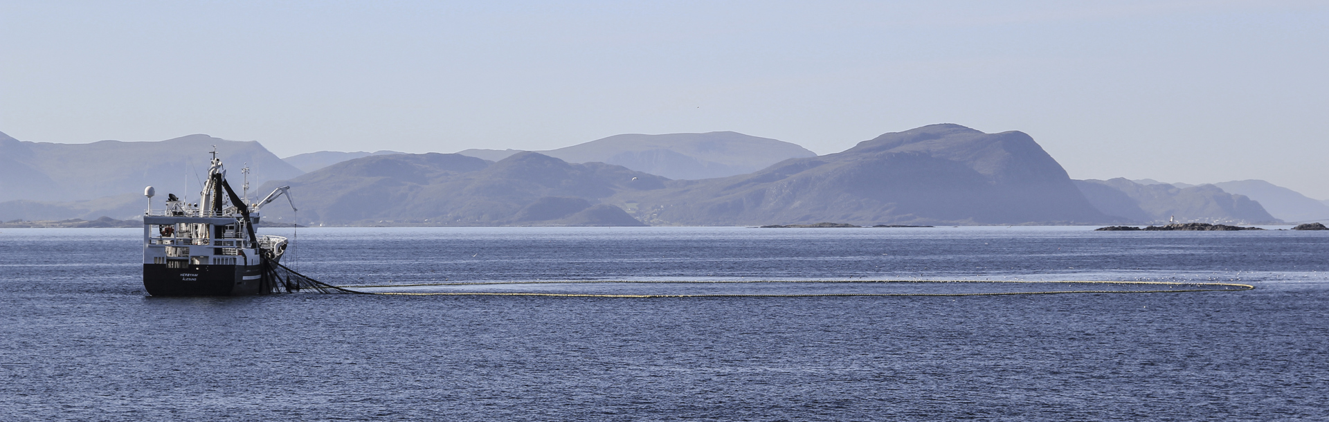 TripleNine-Boat-Sea-Mountains.jpg